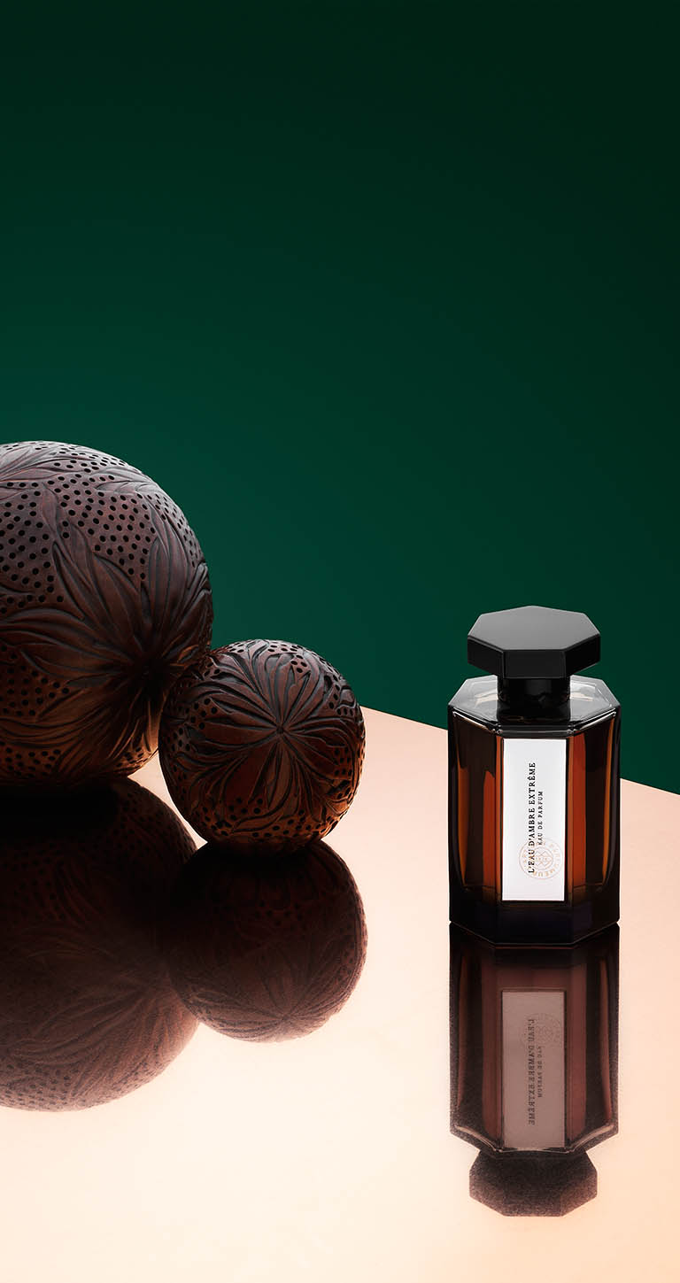 Cosmetics Photography of L'Artisan Parfumeur ambre ball and fragrance bottle by Packshot Factory