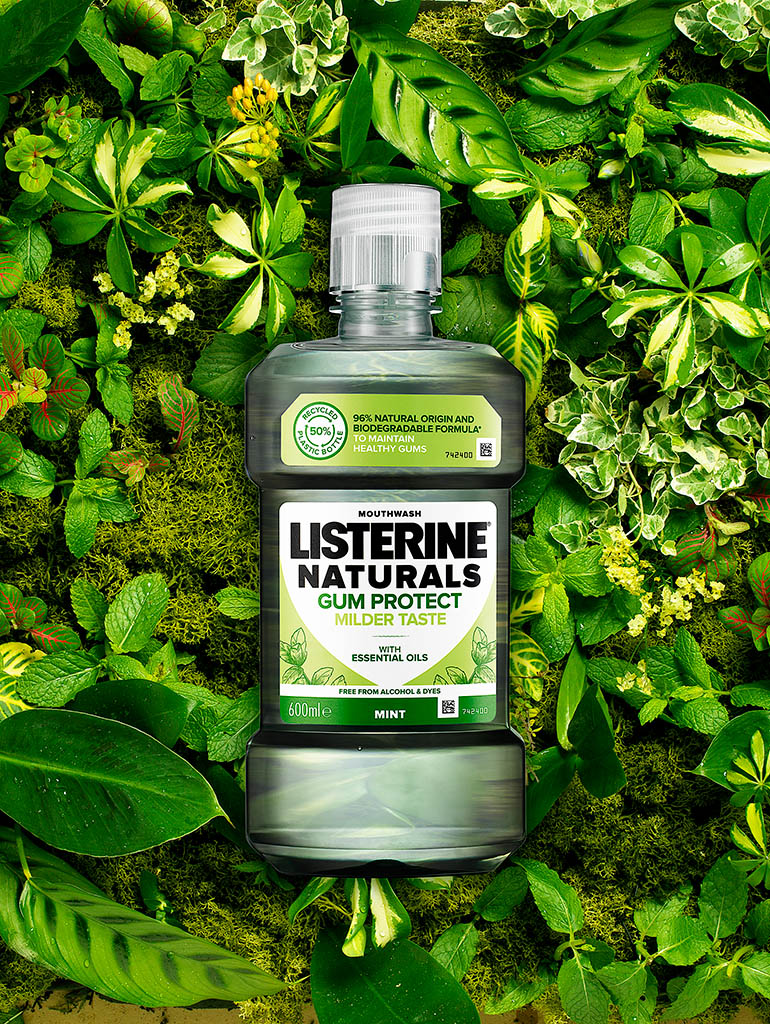 Packshot Factory - Coloured background - Listerine Naturals mouth wash bottle on a bed of foliage