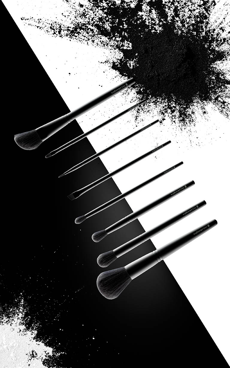 Cosmetics Photography of Illamasqua makeup brushes and powder spill by Packshot Factory