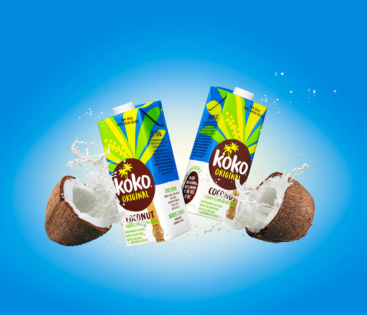 Drinks Photography of Koko milk cartons with smashing coconuts and milk splash by Packshot Factory