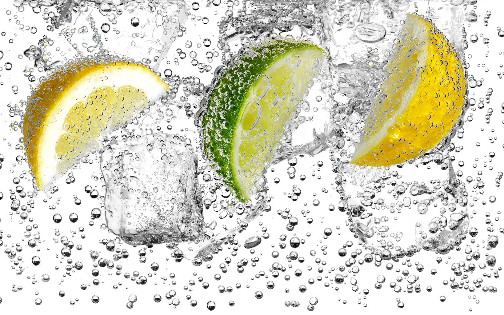 Liquid / Smoke Photography of Lemons and lime in water with ice and bubbles by Packshot Factory