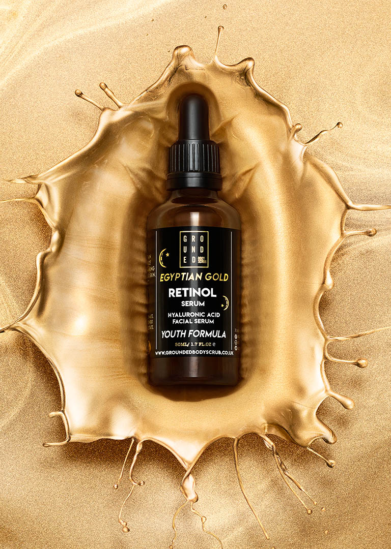 Packshot Factory - Liquid - Grounded serum bottle in gold splash