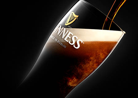 Black background Explorer of Guinness glass beer pour