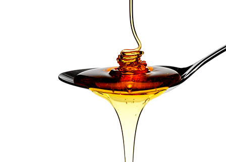Ingredients Explorer of Honey running off spoon