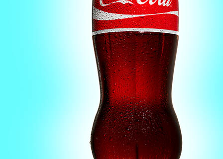 Coloured background Explorer of Coca Cola bottle