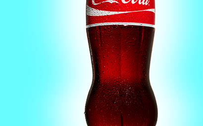 Coloured background Explorer of Coca Cola bottle