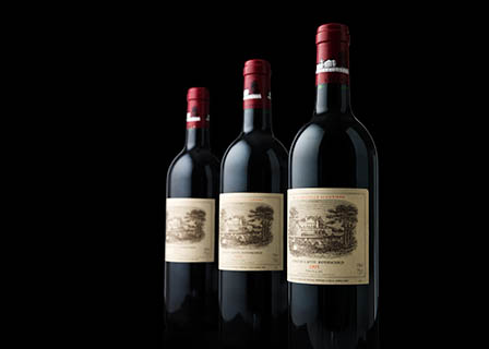 Black background Explorer of Chateau Lafite Rothschild red wine bottles