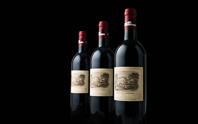 Black background Explorer of Chateau Lafite Rothschild red wine bottles