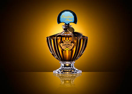 Coloured background Explorer of Guerlain Shalimar perfume bottle