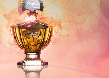 Coloured background Explorer of Guerlain Shalimar perfume bottle and smoke