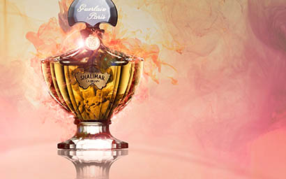 Coloured background Explorer of Guerlain Shalimar perfume bottle and smoke