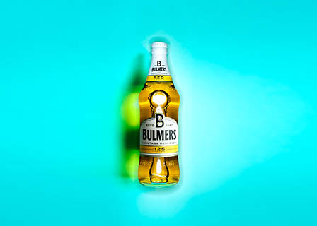 Coloured background Explorer of Bulmers cider bottle