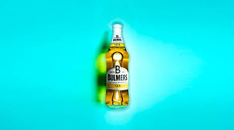 Coloured background Explorer of Bulmers cider bottle