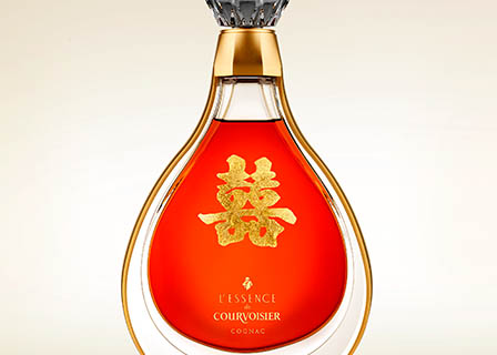 Coloured background Explorer of Courvoisier L'Essence Cognac bottle