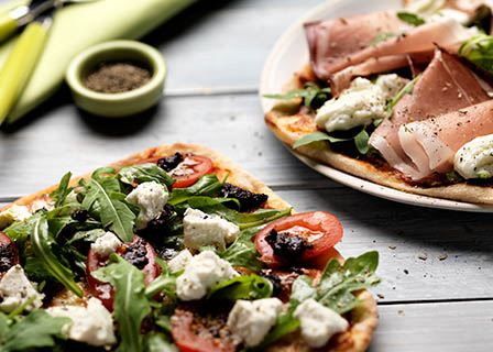 Food Photography of Jamie Oliver flat bread with feta parma ham and rocket