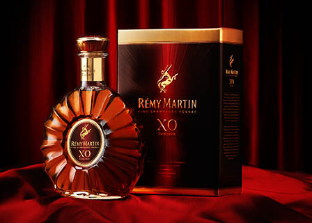 Coloured background Explorer of Remy Martin XO cognac bottle and box