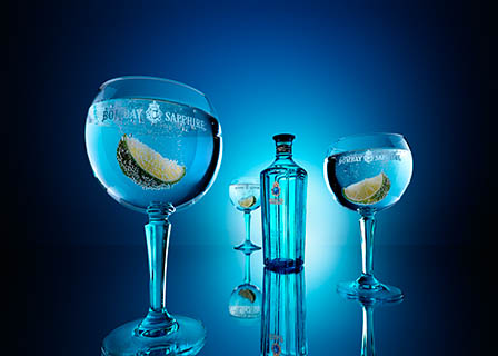 Coloured background Explorer of Bombay Sapphire gin bottle and serve