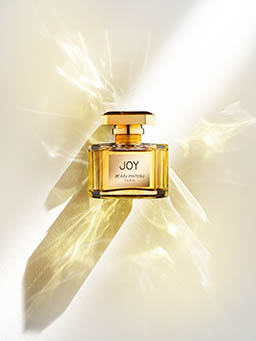 Coloured background Explorer of Joy fragrance bottle