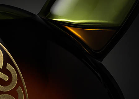 Black background Explorer of Ardbeg whisky bottle neck close up