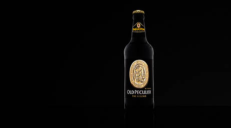 Black background Explorer of Old Peculier beer bottle