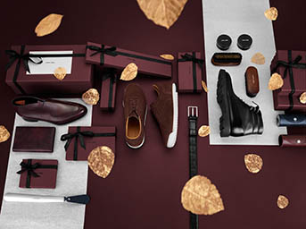 Coloured background Explorer of John Lobb men's leather shoes and accessorie