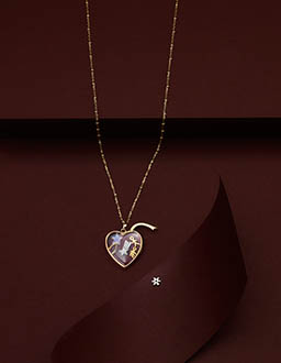 Coloured background Explorer of Loquet London gold chain with heart pendant