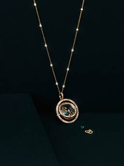 Coloured background Explorer of Loquet London gold necklace with diamonds