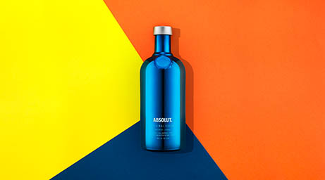 Coloured background Explorer of Absolut vodka bottle