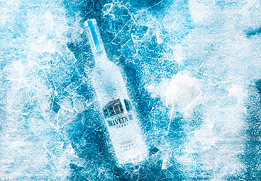 Coloured background Explorer of Belvedere vodka bottle