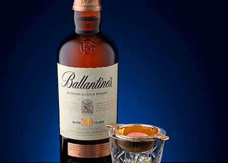 Coloured background Explorer of Ballantine's whisky bottle and serve