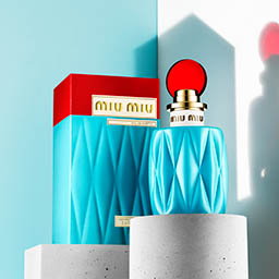 Coloured background Explorer of Miu Miu fragrance bottle