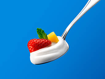 Snack Explorer of Koko yoghurt on a spoon with fruits