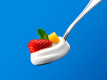 Ingredients Explorer of Koko yoghurt on a spoon with fruits