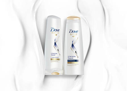 Cosmetics Photography of Dove shampoo and conditioner bottles with texture