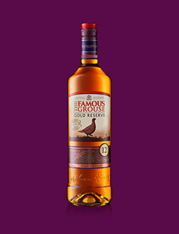 Coloured background Explorer of Famous Grouse whisky bottle