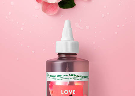 Coloured background Explorer of Love Beauty and Planet hair care shampoo with ingredients
