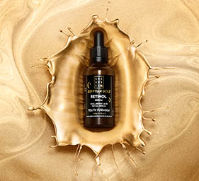 Cosmetics Photography of Grounded serum bottle in gold splash