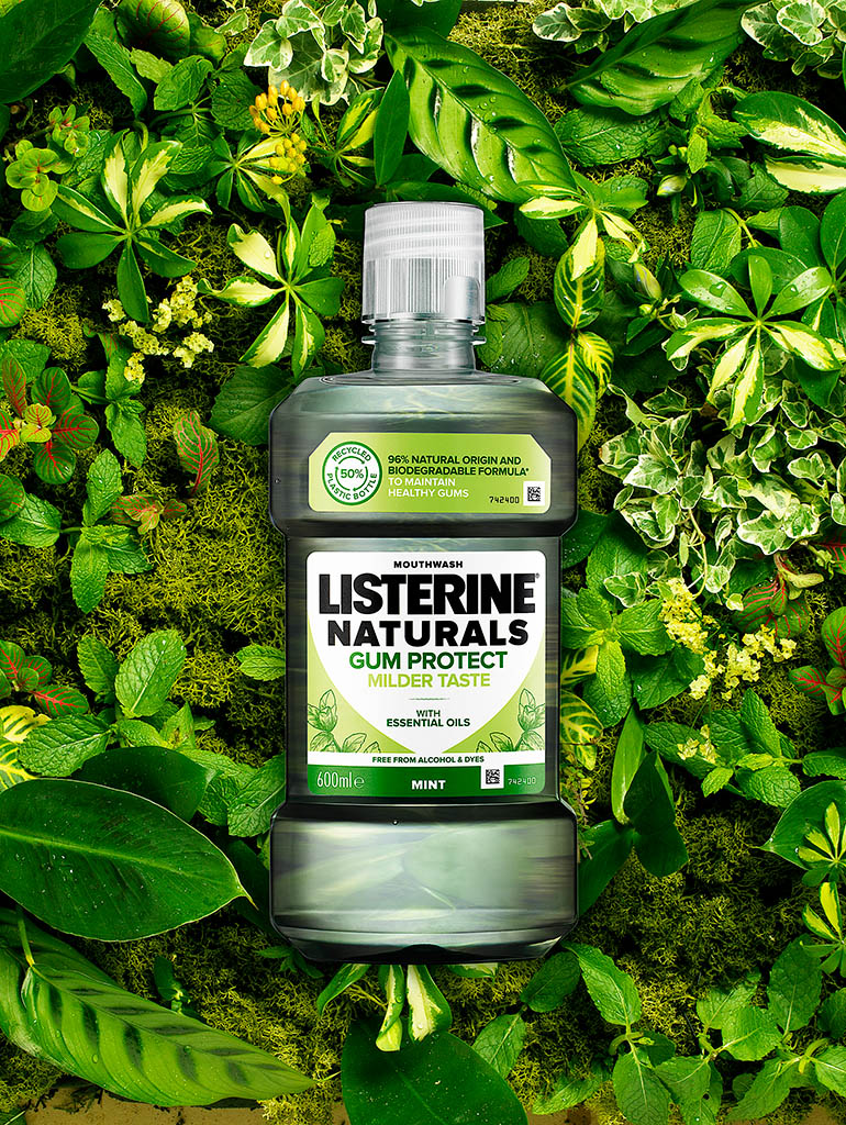 Advertising Still Life Product Photography of Listerine Naturals mouth wash bottle on a bed of foliage by Packshot Factory